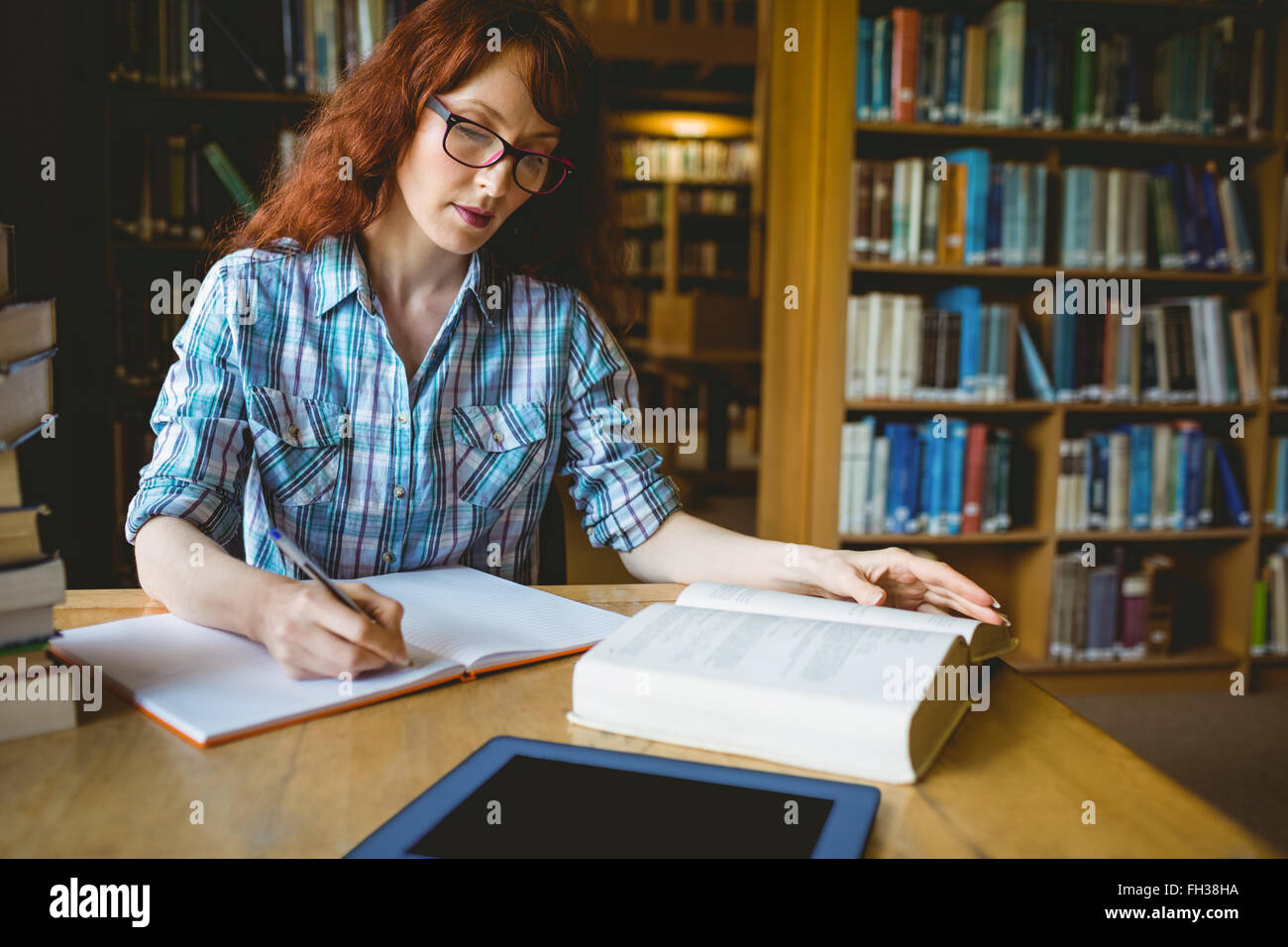 Mature student studying in library Stock Photo