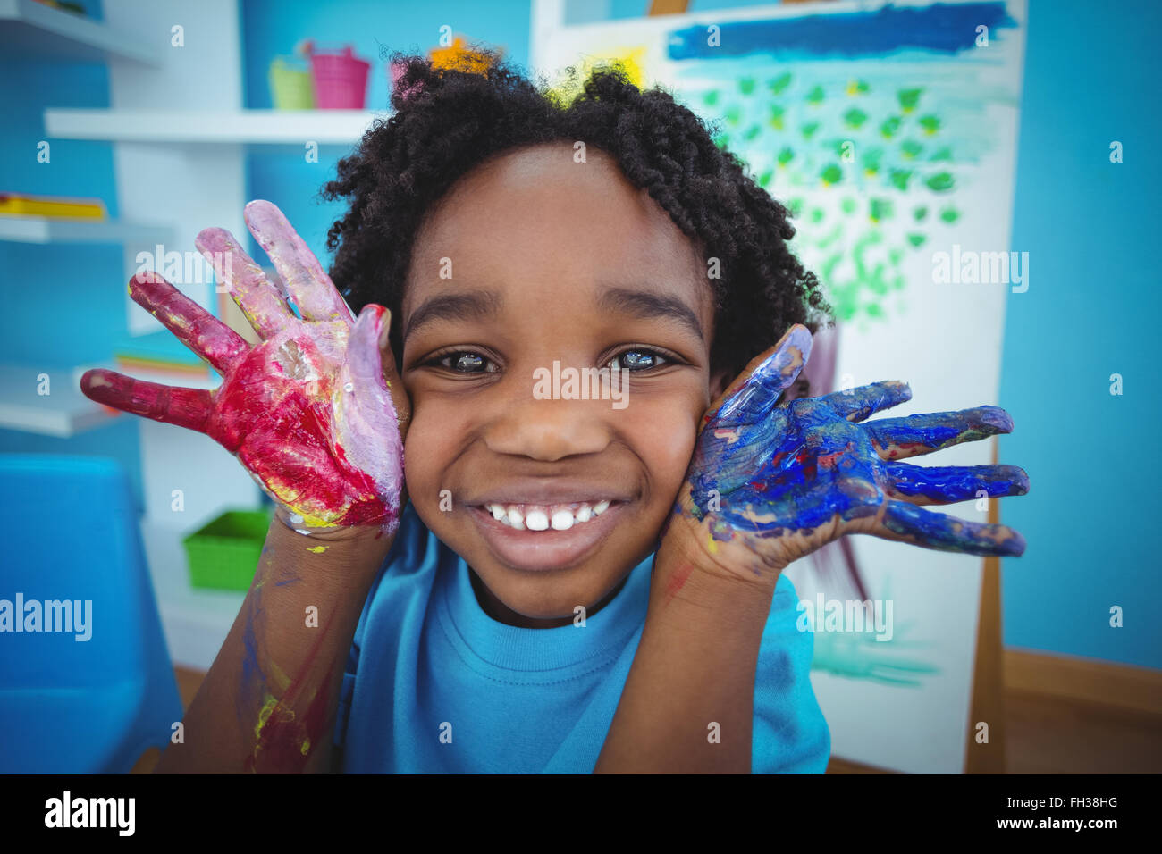 Happy kid enjoying arts and crafts painting Stock Photo