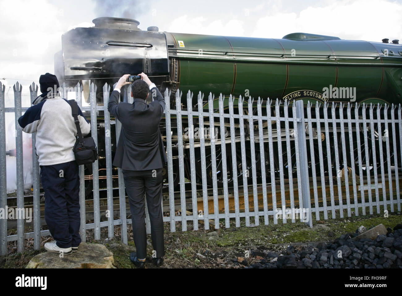 York, UK. 23rd February, 2016. Spectators watch as the newly restored LNER A3 class locomotive “Flying Scotsman” prepares to travel from York to Scarborough on a final test run before its inaugural comeback journey from London King's Cross to York on Thursday 25 February. The locomotive, owned by the National Railway Museum (NRM), has been fully restored at a cost of £4.2 million and in addition to featuring in a new exhibition at the NRM's York location will be hauling special trains throughout the UK in the coming months. Credit:  david soulsby/Alamy Live News Stock Photo