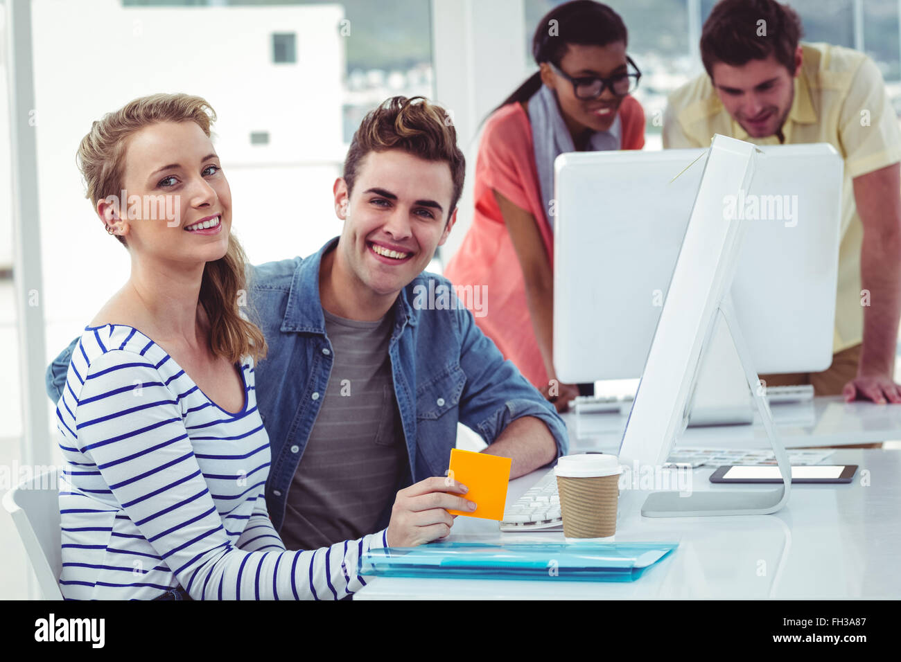Creative business team working hard together on pc Stock Photo - Alamy