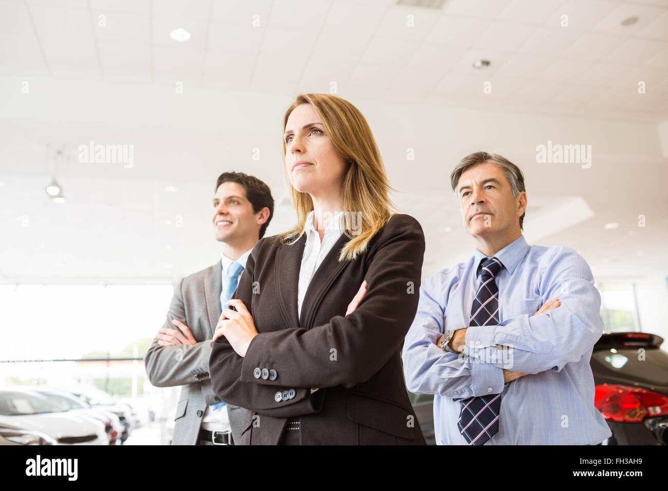 Group of smiling business team standing together Stock Photo - Alamy