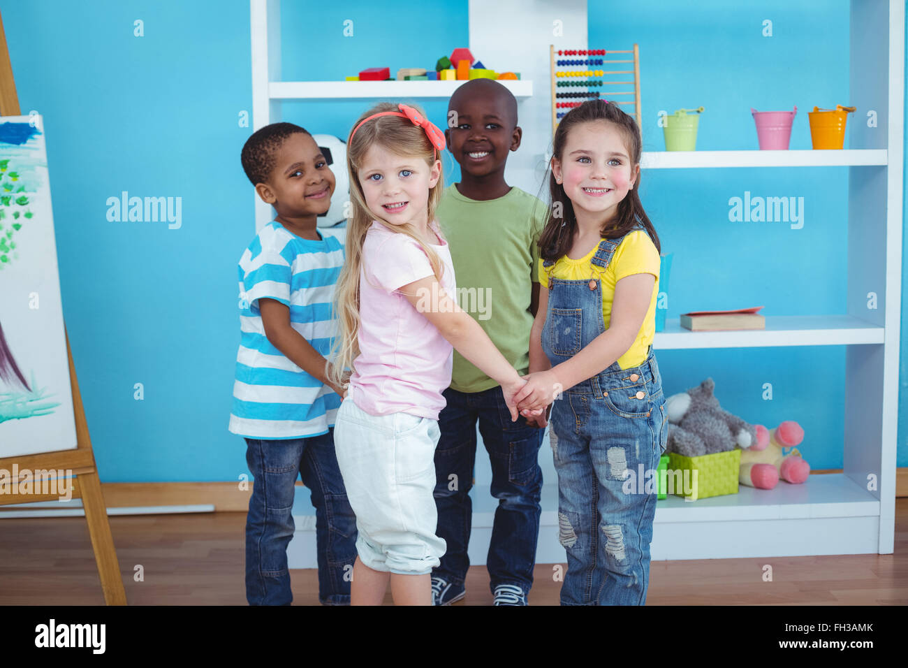 Happy kids holding hands together Stock Photo - Alamy