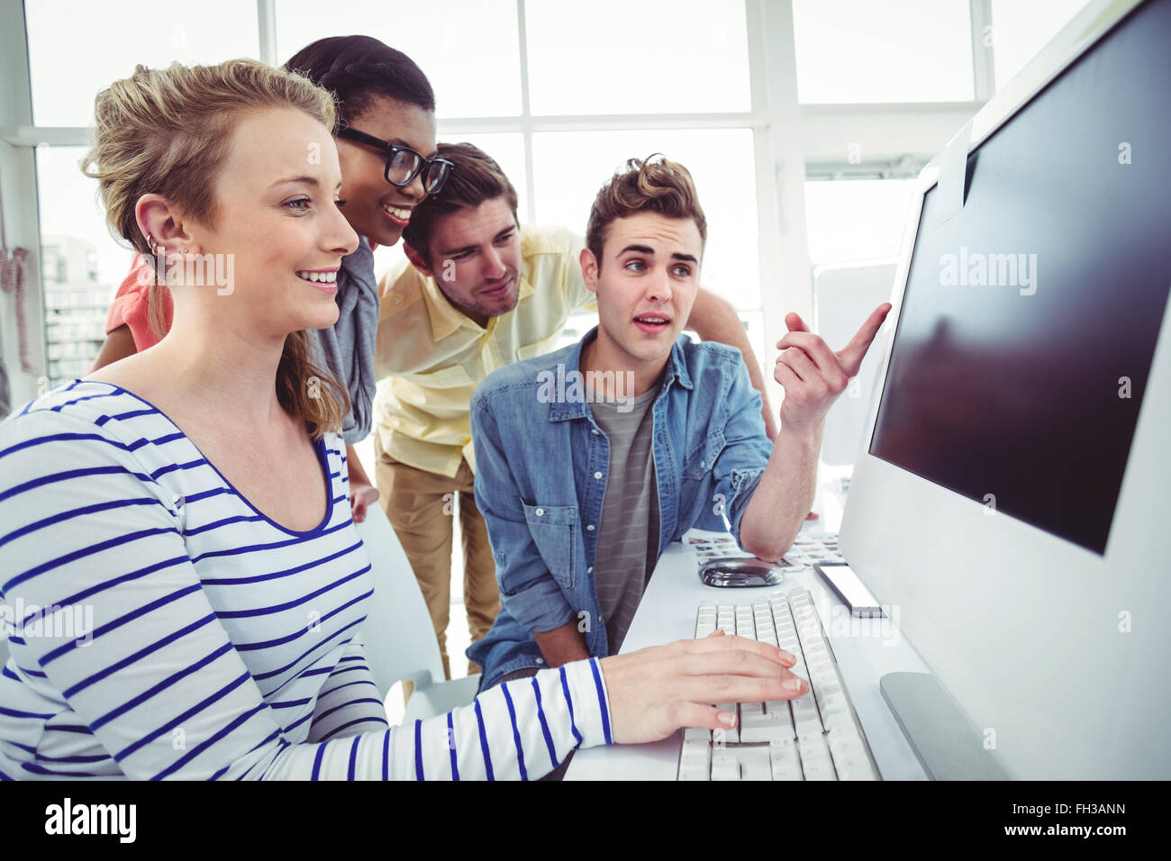 Creative business team working hard together on pc Stock Photo - Alamy