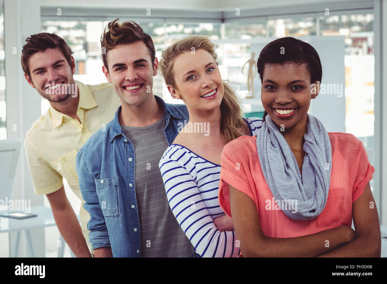 Smiling creative team standing in a line Stock Photo - Alamy