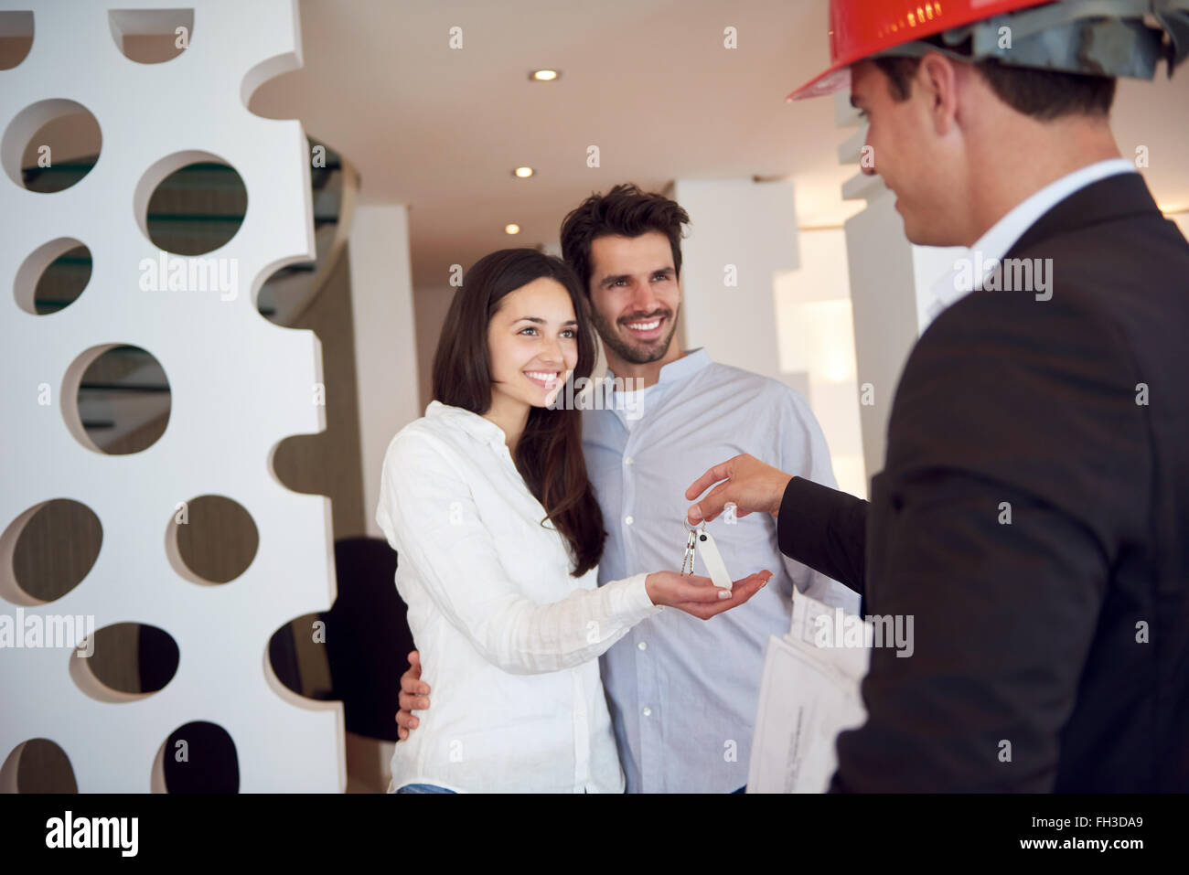couple buying new home with real estate agent Stock Photo Alamy