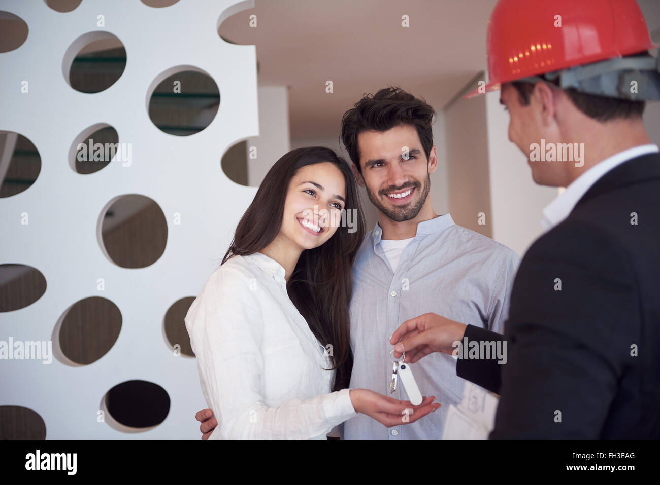 couple buying new home with real estate agent Stock Photo Alamy