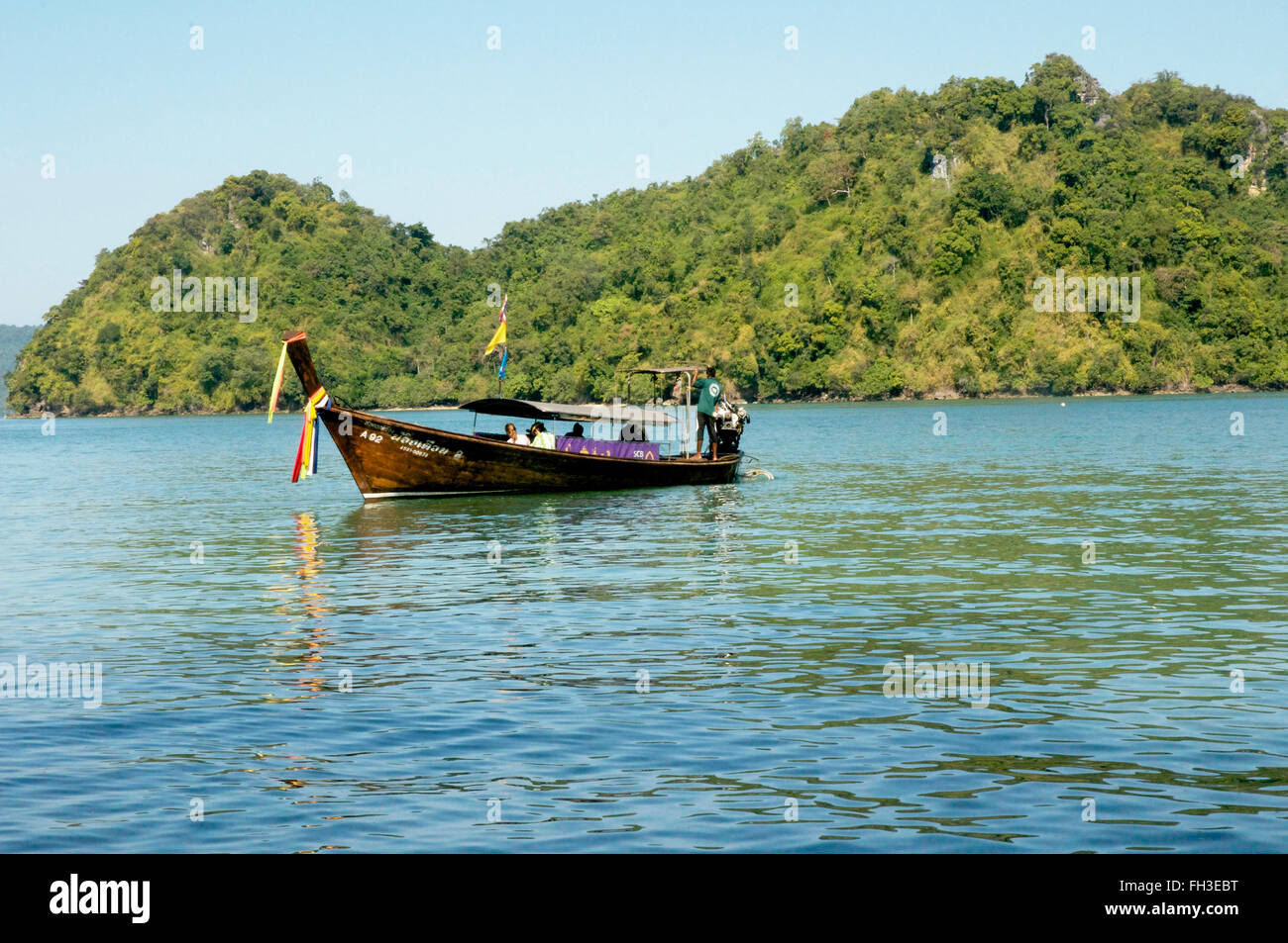Longtail boat with passengers and driver. Stock Photo