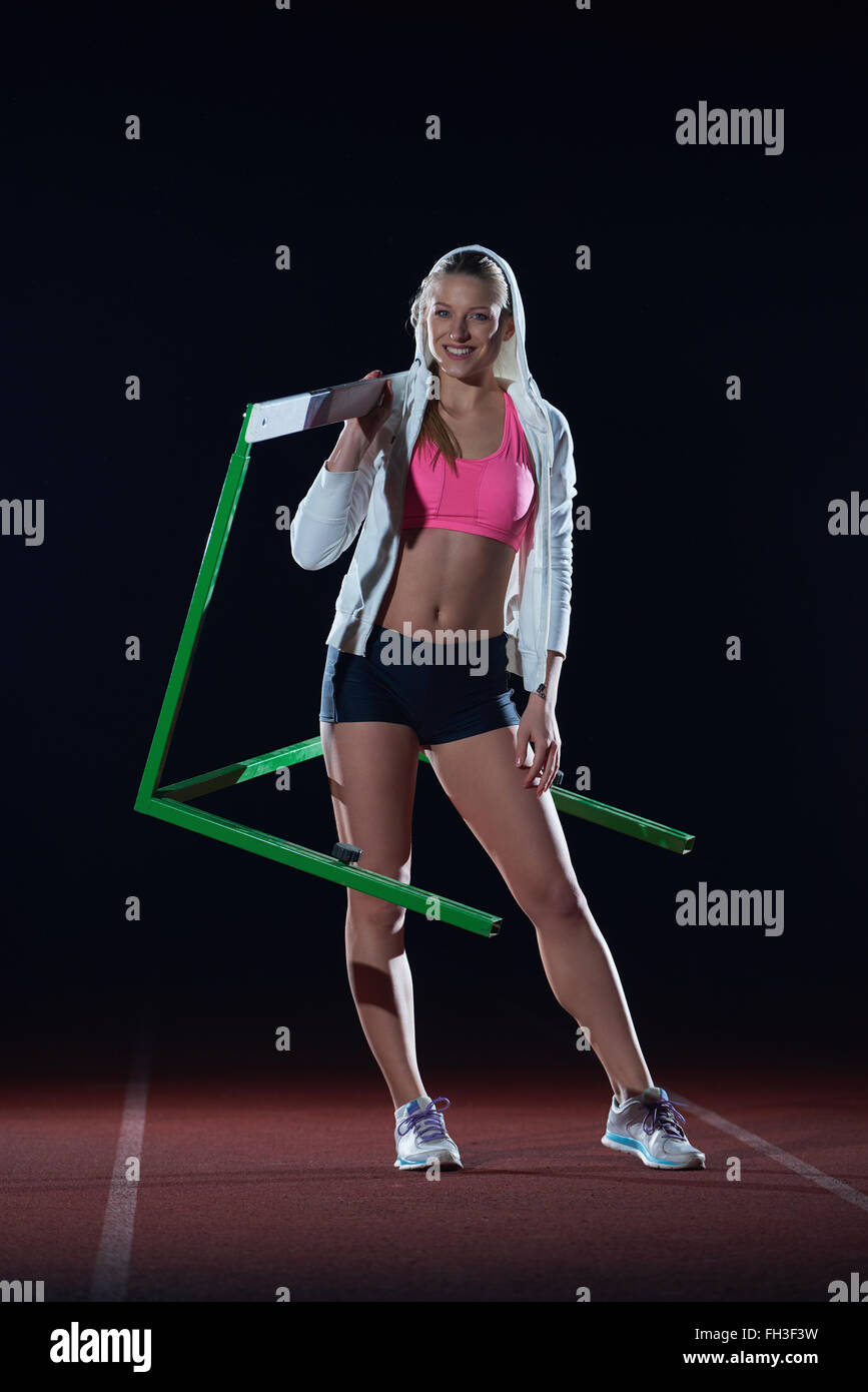 woman athlete jumping over a hurdles Stock Photo - Alamy