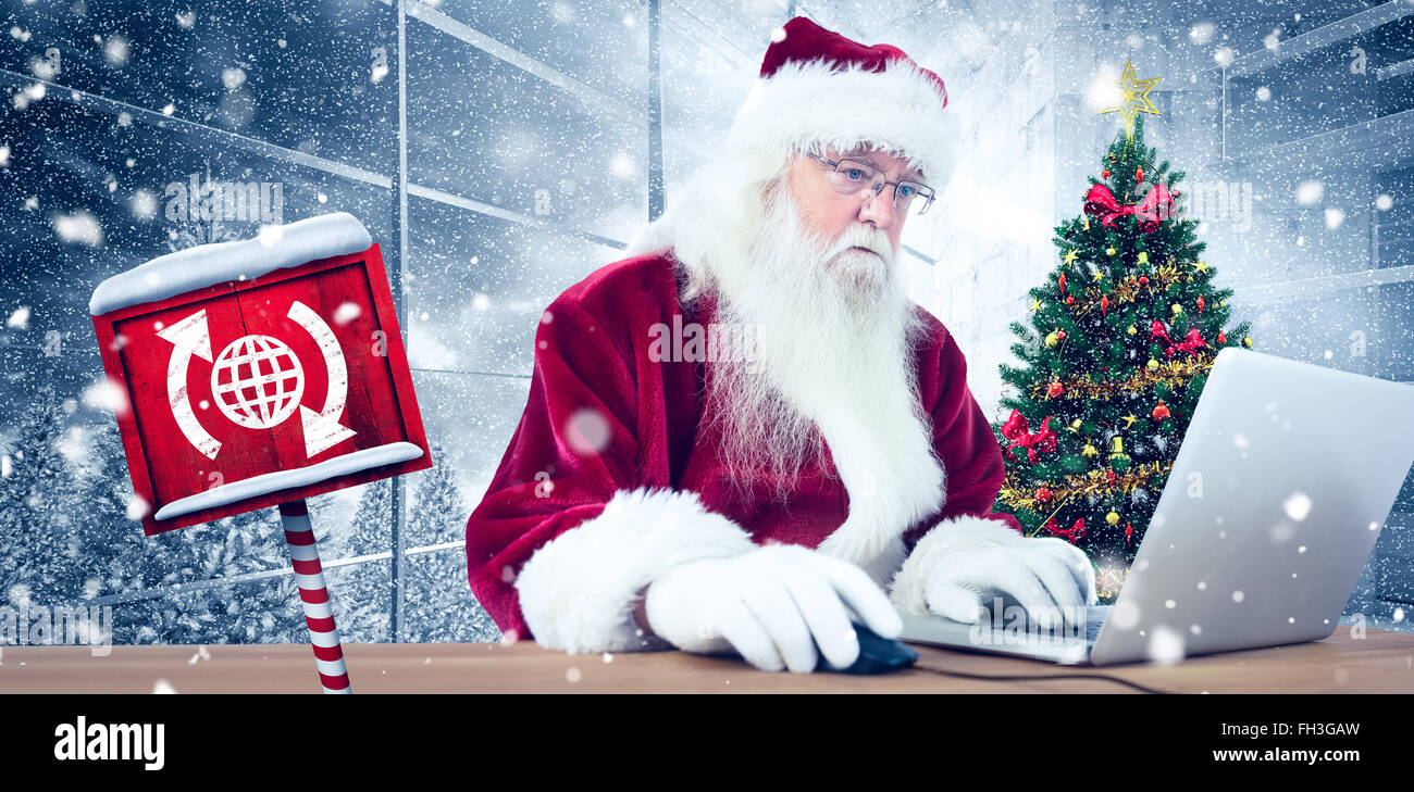 Composite image of santa surfs on the internet Stock Photo