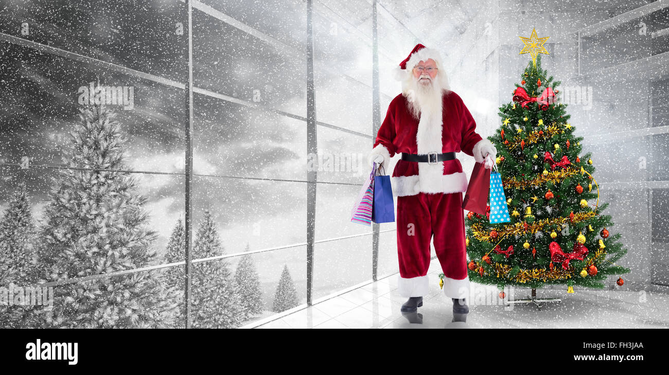 Composite image of santa carries some christmas bags Stock Photo - Alamy