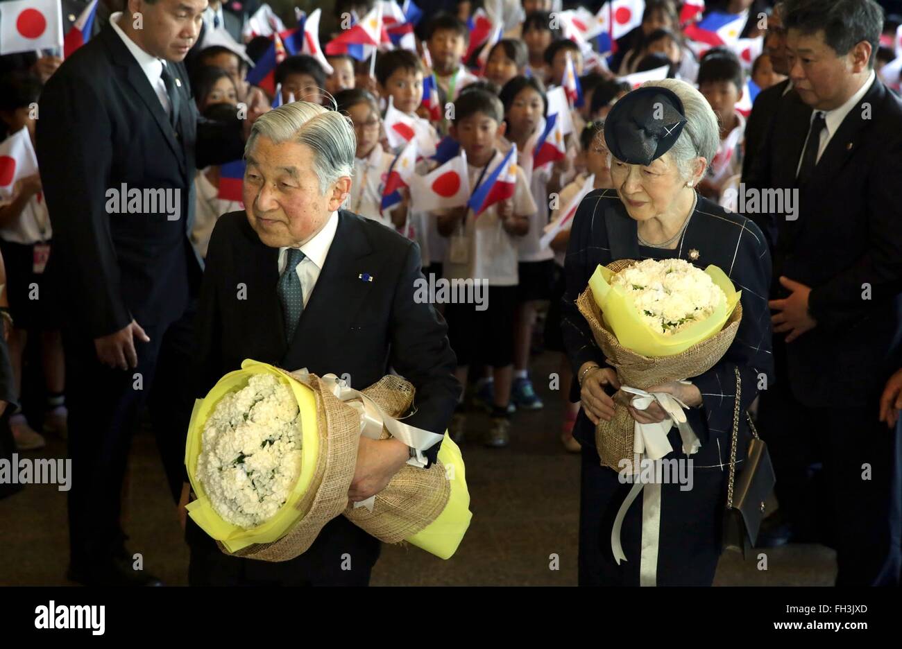 Japanese Emperor Akihito and his wife Empress Michiko are welcomed by students of the Manila Japanese School at Sofitel Philippine Plaza January 26, 2016 in Manila, Philippines. The Imperial Couple are on a five-day state visit marking the 60th anniversary of Philippine-Japanese diplomatic relations. Stock Photo