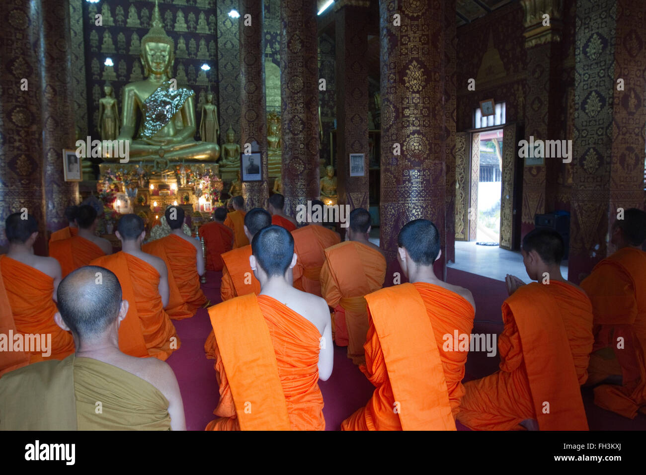 Monks attending their evening prayers  Luang Prabang Laos Stock Photo