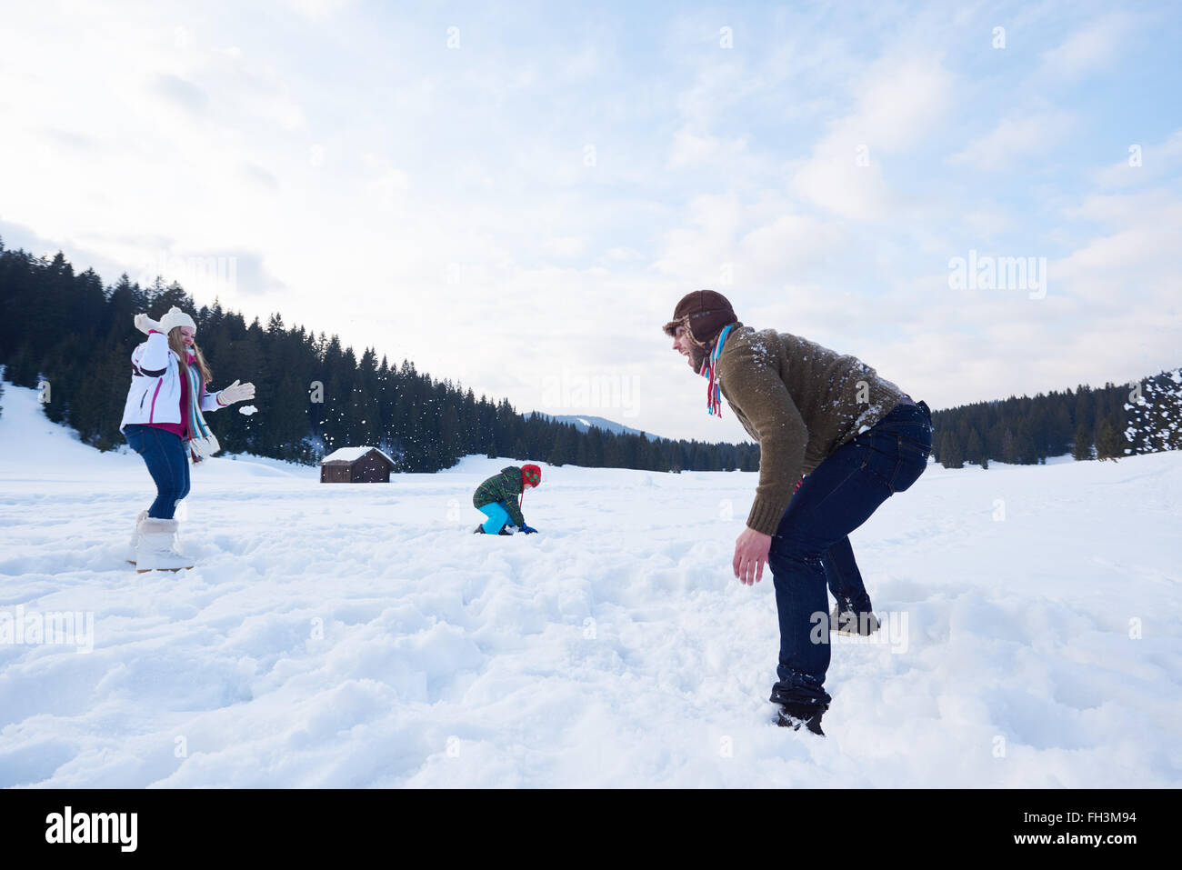 happy family playing together in snow at winter Stock Photo - Alamy