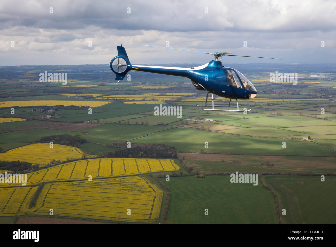 A Cabri G2 helicopter made by Guimbal flying over the cotswold