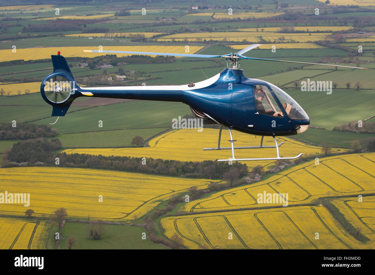 A Cabri G2 helicopter made by Guimbal flying over the cotswold