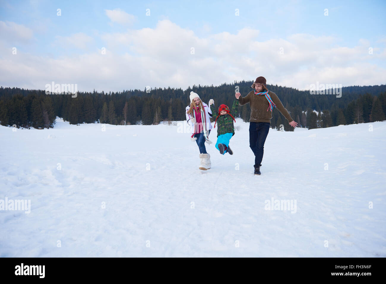 happy family playing together in snow at winter Stock Photo - Alamy