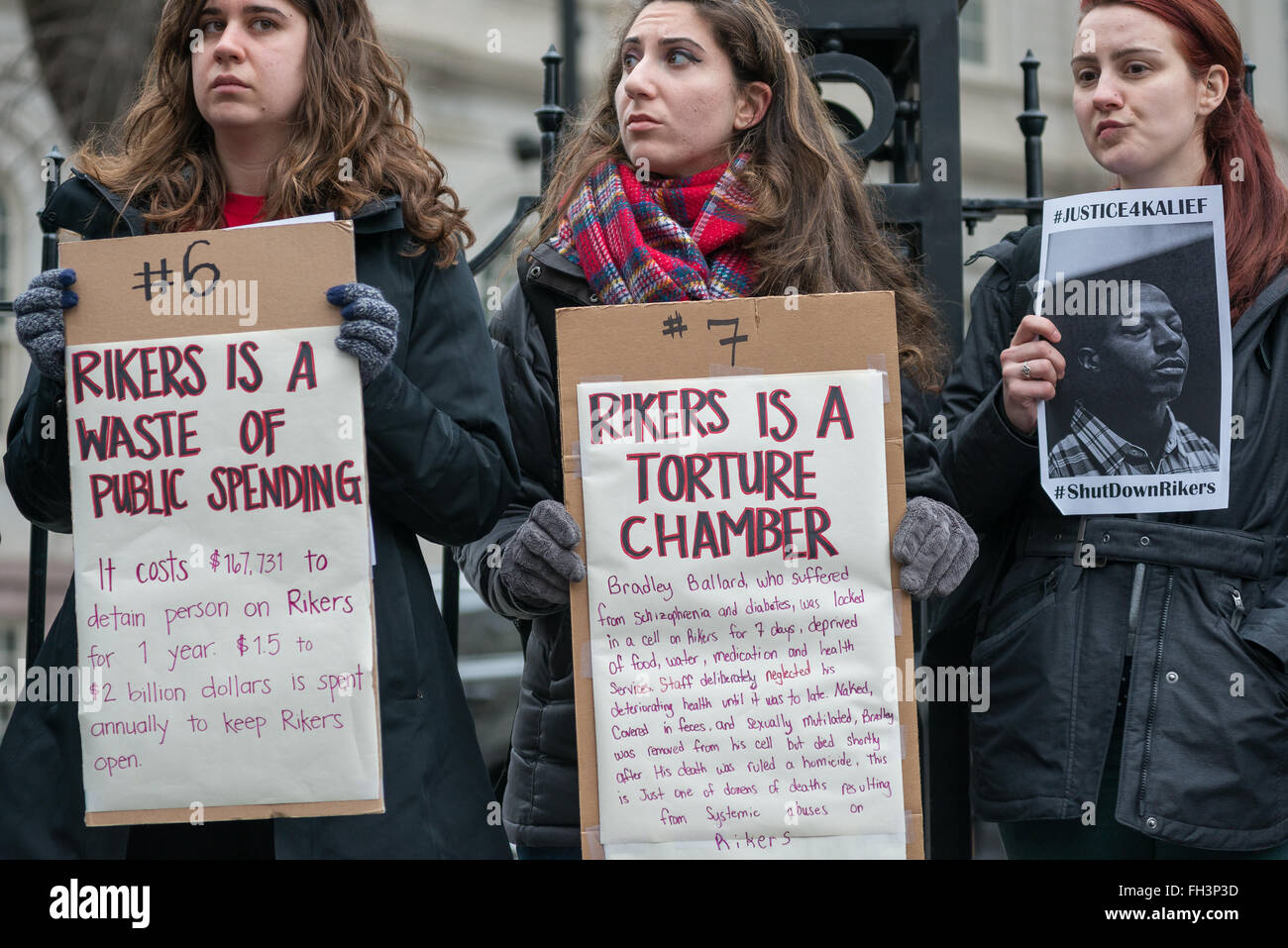 New York, United States. 23rd Feb, 2016. Demonstrators hold aloft signs inscribed with the reasons that they deman Rikers Island be closed. A confederacy of about a dozen prison reform activists rallied at City Hall in New York City to demand that it close the long-controversial Rikers Island Corrections facility where, among others, Kalief Browder, died; critics maintain that the prison is unsafe and prolonged detention of inmates at the facility is a violation of Constitutional due process rights. Credit:  Albin Lohr-Jones/Pacific Press/Alamy Live News Stock Photo