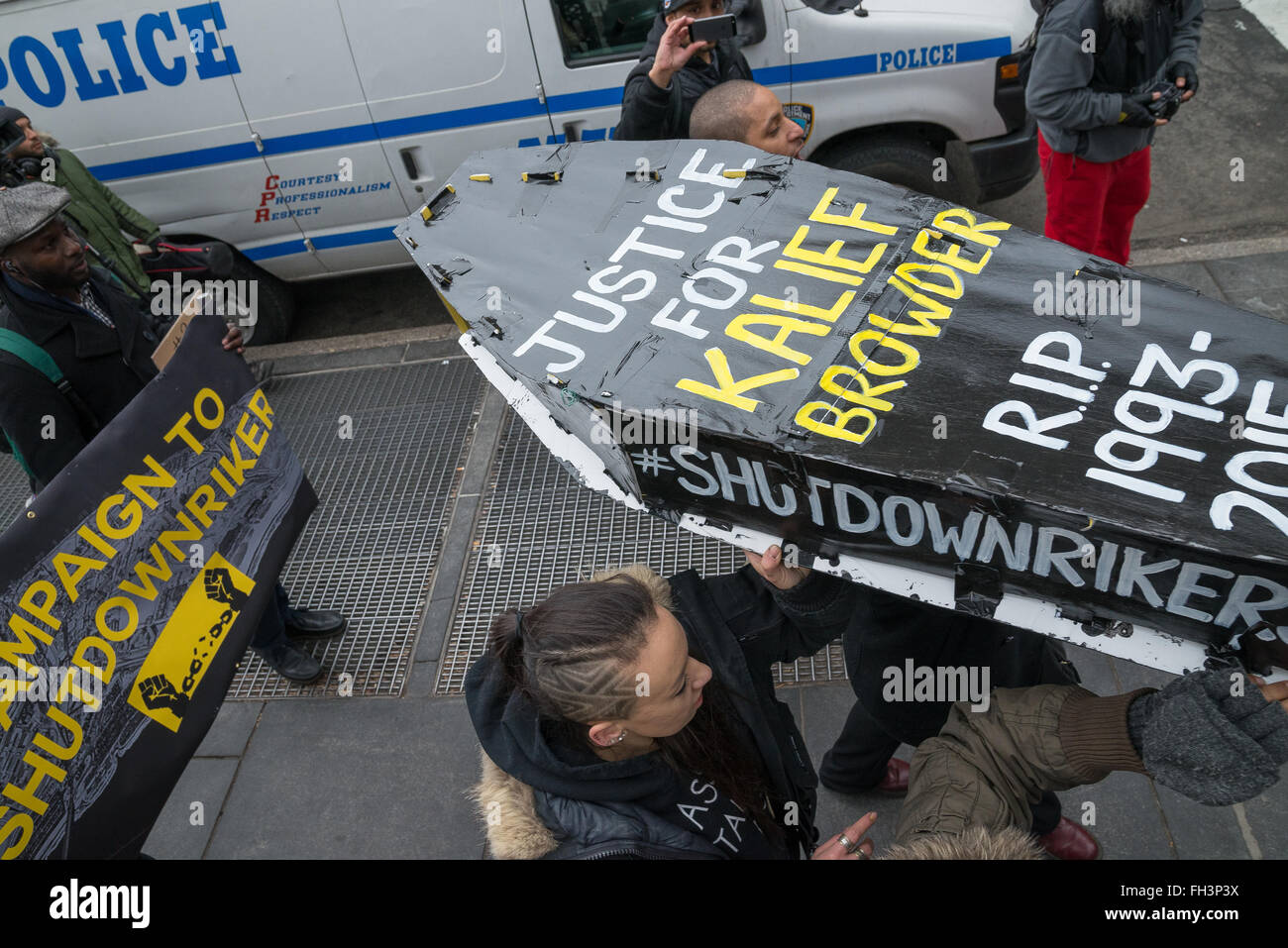 New York, United States. 23rd Feb, 2016. Demonstrators carry aloft a symbolic coffin bearing the name of Kalief Browder as they march outside NYC's City Hall. A confederacy of about a dozen prison reform activists rallied at City Hall in New York City to demand that it close the long-controversial Rikers Island Corrections facility where, among others, Kalief Browder, died; critics maintain that the prison is unsafe and prolonged detention of inmates at the facility is a violation of Constitutional due process rights. Credit:  Albin Lohr-Jones/Pacific Press/Alamy Live News Stock Photo