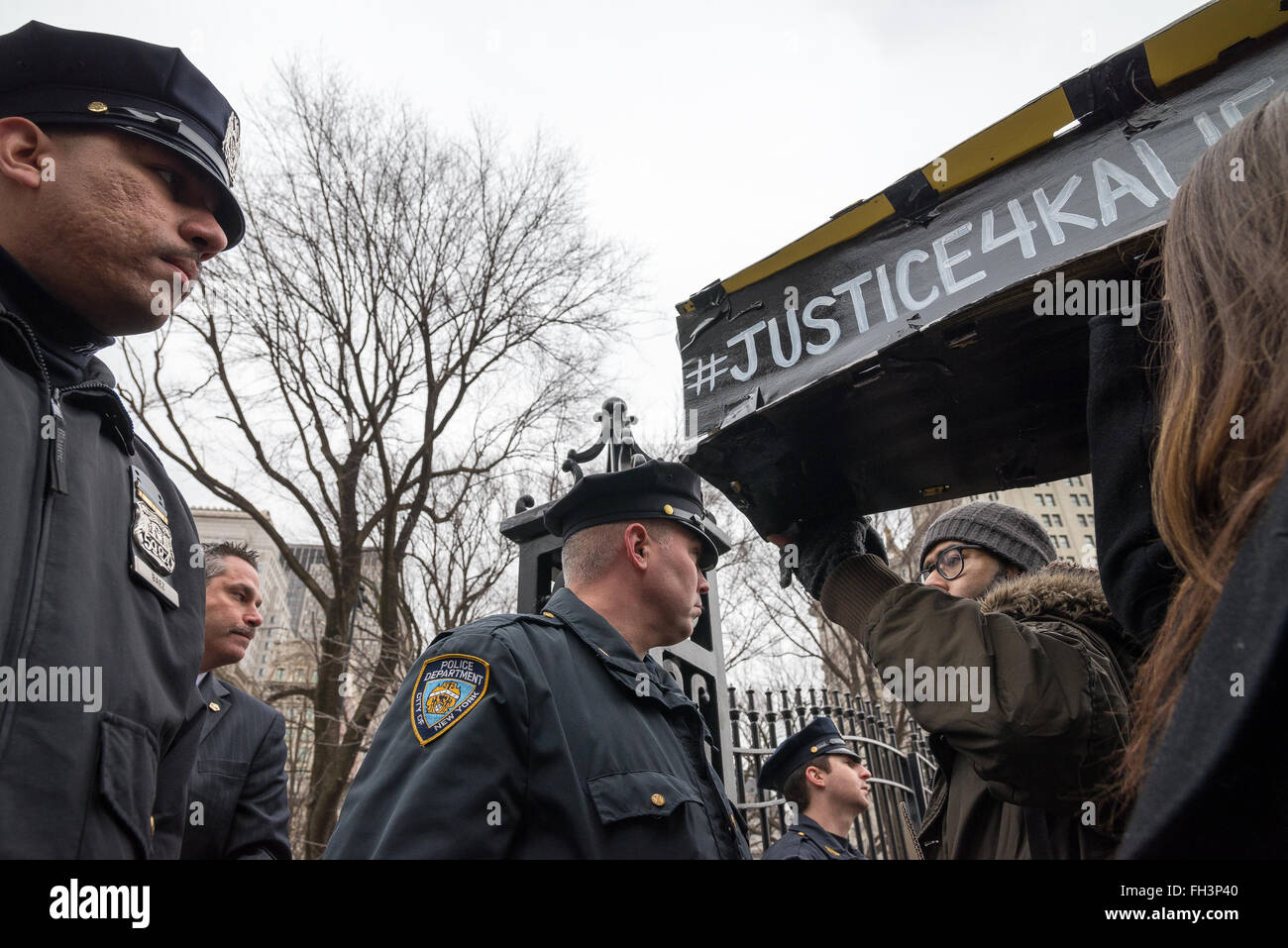 New York, United States. 23rd Feb, 2016. NYPD officers standing guard at the City Hall entrance gate refuse to allow demonstrators carrying aloft a symbolic coffin. to enter. A confederacy of about a dozen prison reform activists rallied at City Hall in New York City to demand that it close the long-controversial Rikers Island Corrections facility where, among others, Kalief Browder, died; critics maintain that the prison is unsafe and prolonged detention of inmates at the facility is a violation of Constitutional due process rights. Credit:  Albin Lohr-Jones/Pacific Press/Alamy Live News Stock Photo