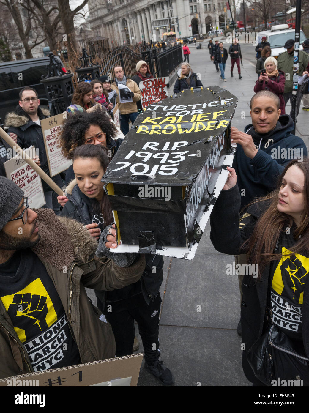 New York, United States. 23rd Feb, 2016. Demonstrators carry aloft a symbolic coffin bearing the name of Kalief Browder as they march outside NYC's City Hall. A confederacy of about a dozen prison reform activists rallied at City Hall in New York City to demand that it close the long-controversial Rikers Island Corrections facility where, among others, Kalief Browder, died; critics maintain that the prison is unsafe and prolonged detention of inmates at the facility is a violation of Constitutional due process rights. Credit:  Albin Lohr-Jones/Pacific Press/Alamy Live News Stock Photo