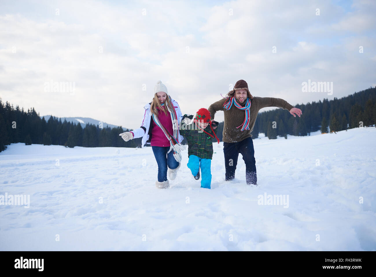 happy family playing together in snow at winter Stock Photo - Alamy