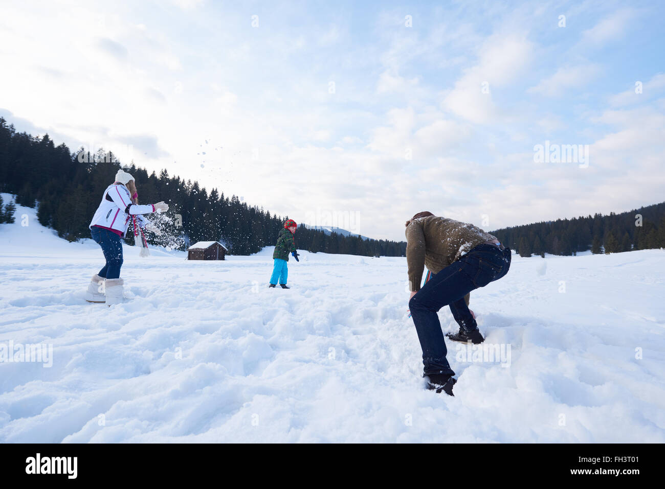 happy family playing together in snow at winter Stock Photo - Alamy