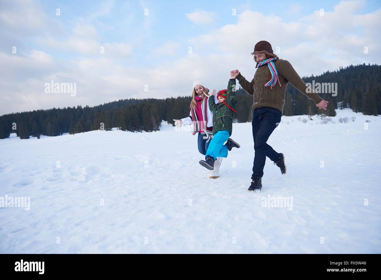 happy family playing together in snow at winter Stock Photo - Alamy