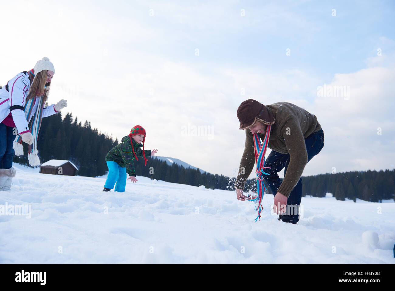 happy family playing together in snow at winter Stock Photo - Alamy