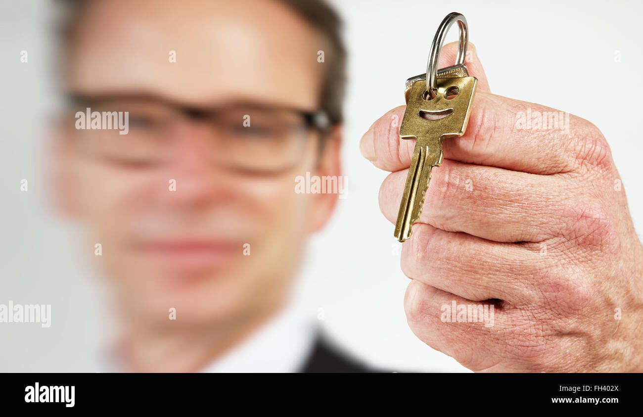 Close-up of house keys held by house agent Stock Photo