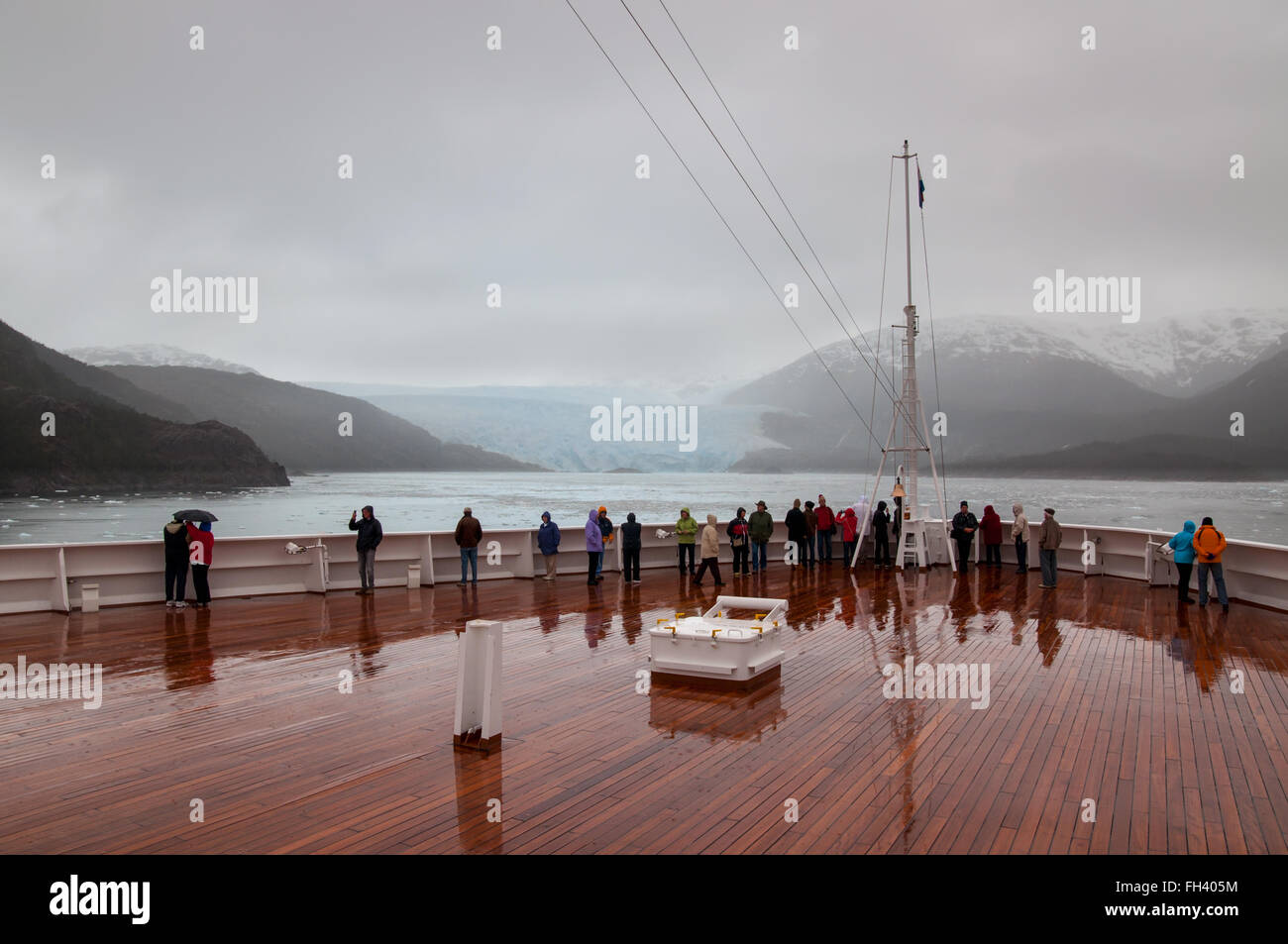 Passengers on board the cruise ship Veendam viewing beautiful Amilia Glacier Stock Photo