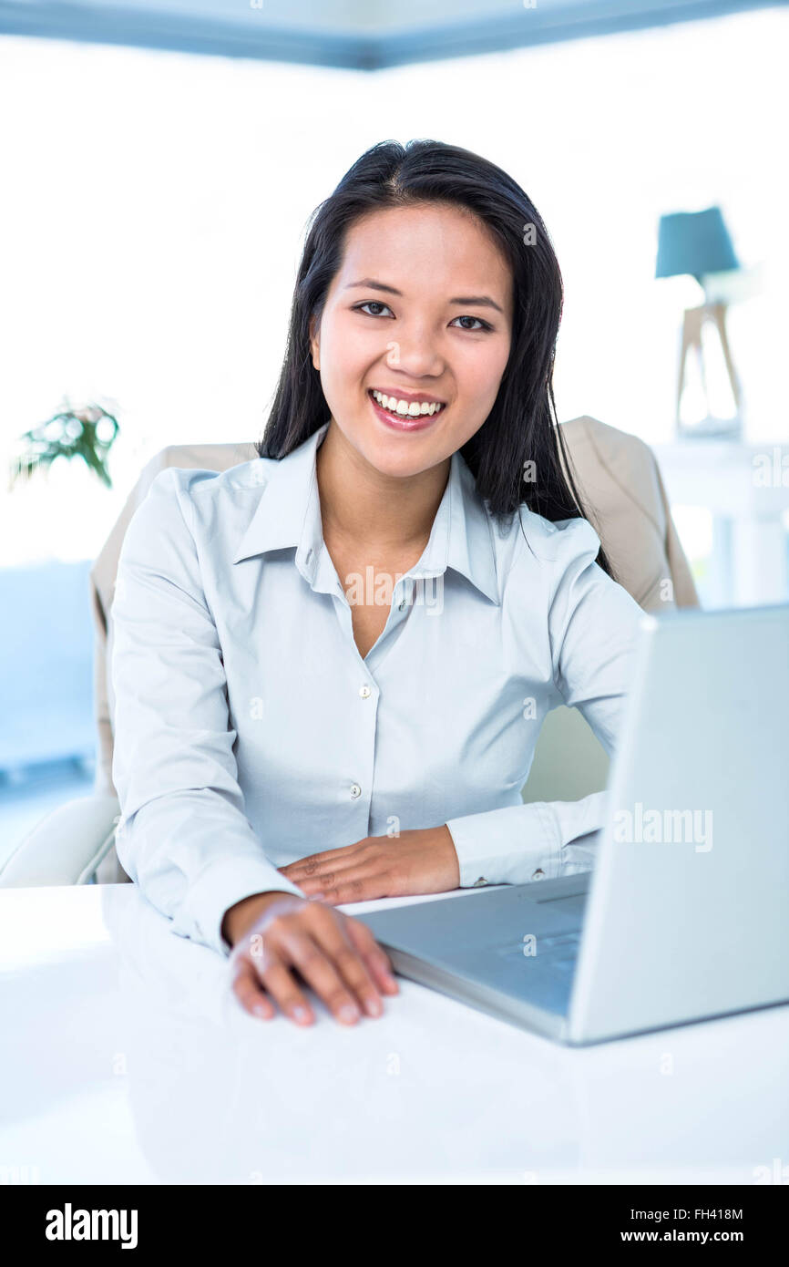 Smiling businesswoman at her desk Stock Photo - Alamy