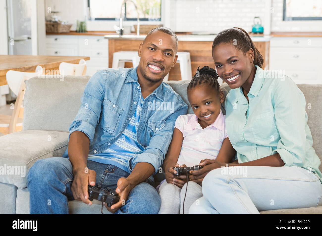 Happy family playing video games Stock Photo - Alamy