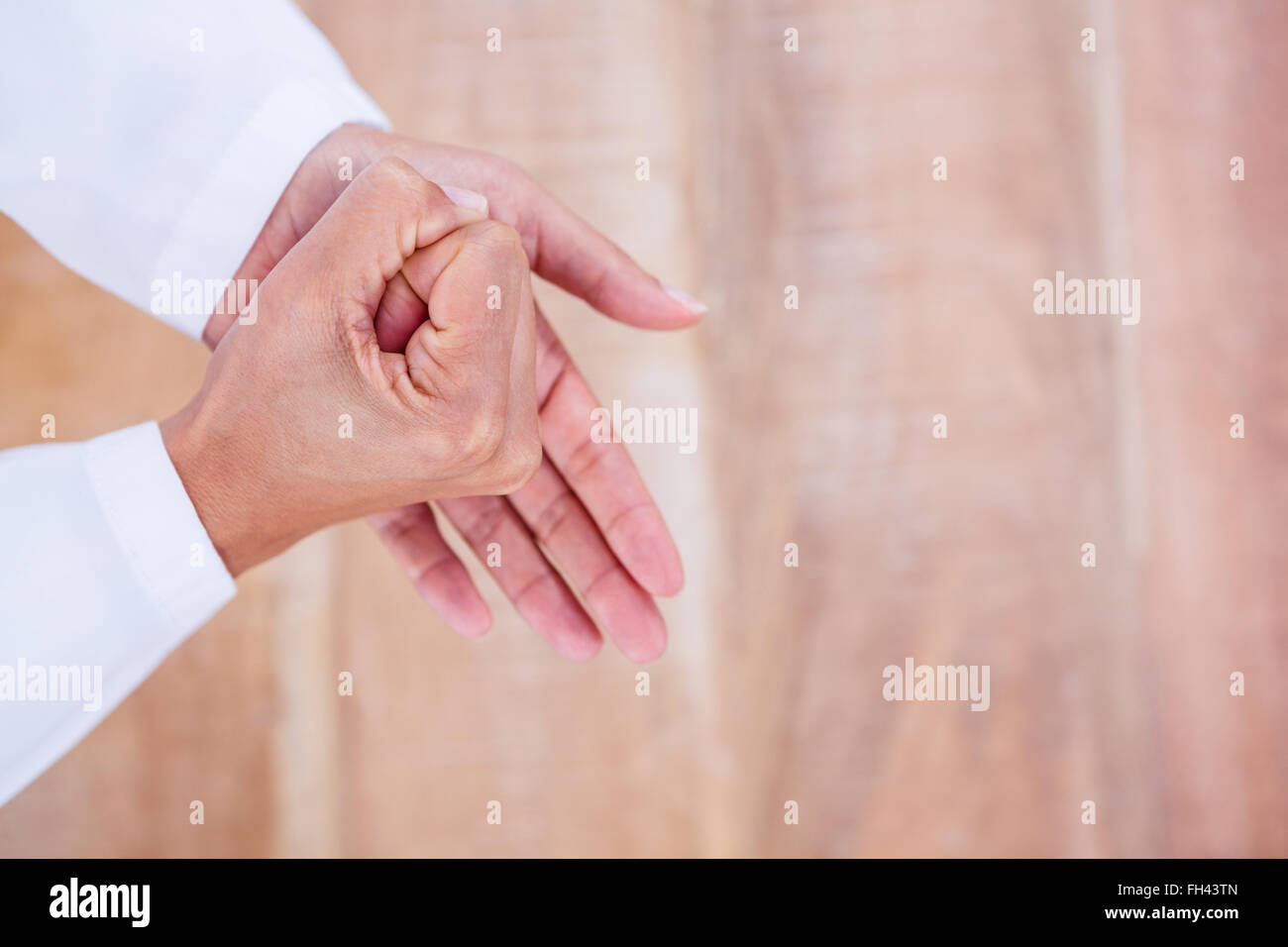 Close up view of hands on wood desk Stock Photo