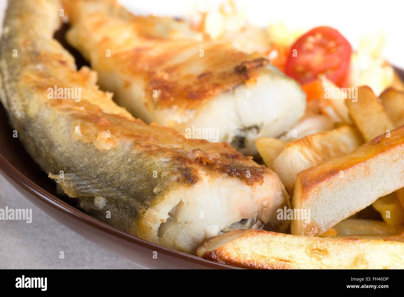 fried fish saffron cod with potatoes and vegetables Stock Photo Alamy