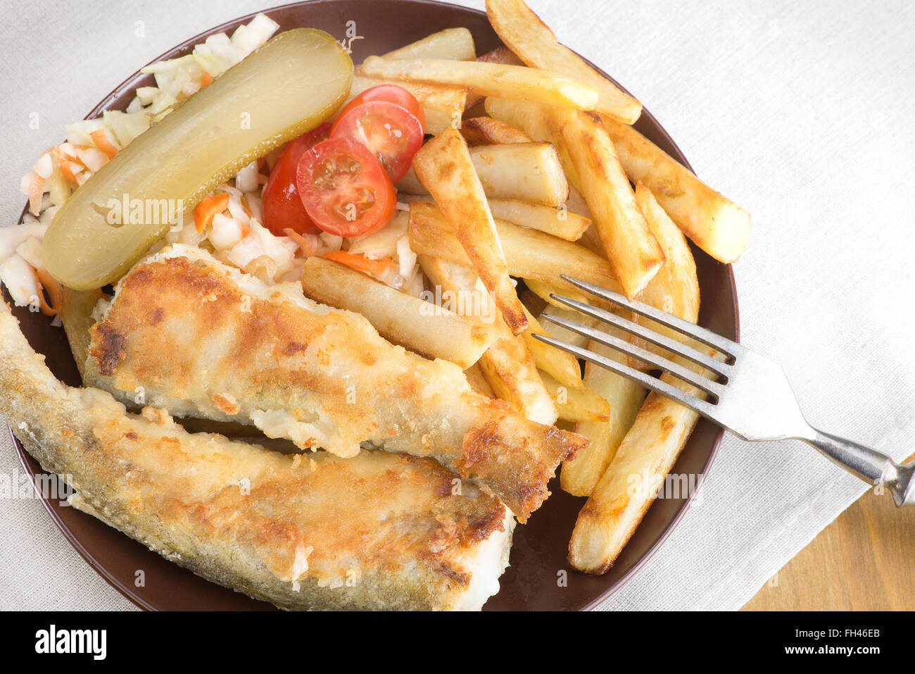 fried fish saffron cod with potatoes and vegetables Stock Photo Alamy