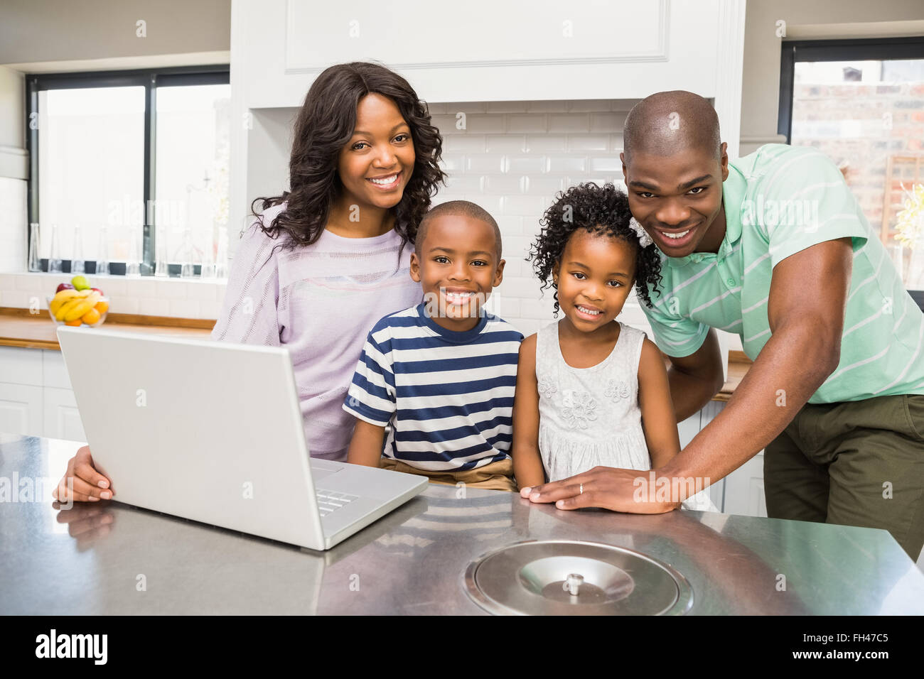 Happy family using laptop Stock Photo - Alamy