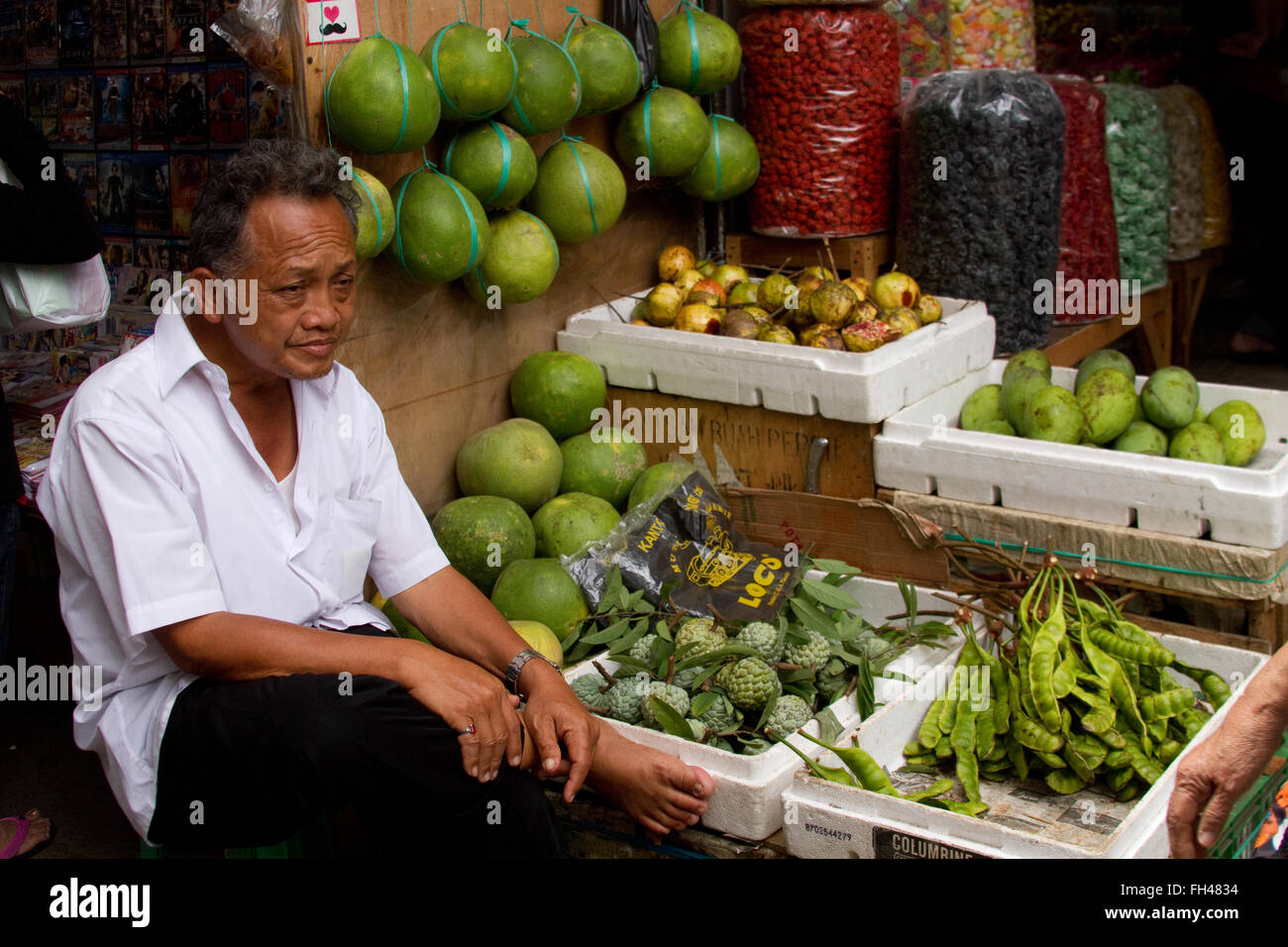 Street seller with his vegetables and fruits in Chinatown  Jakarta Indonesia Stock Photo