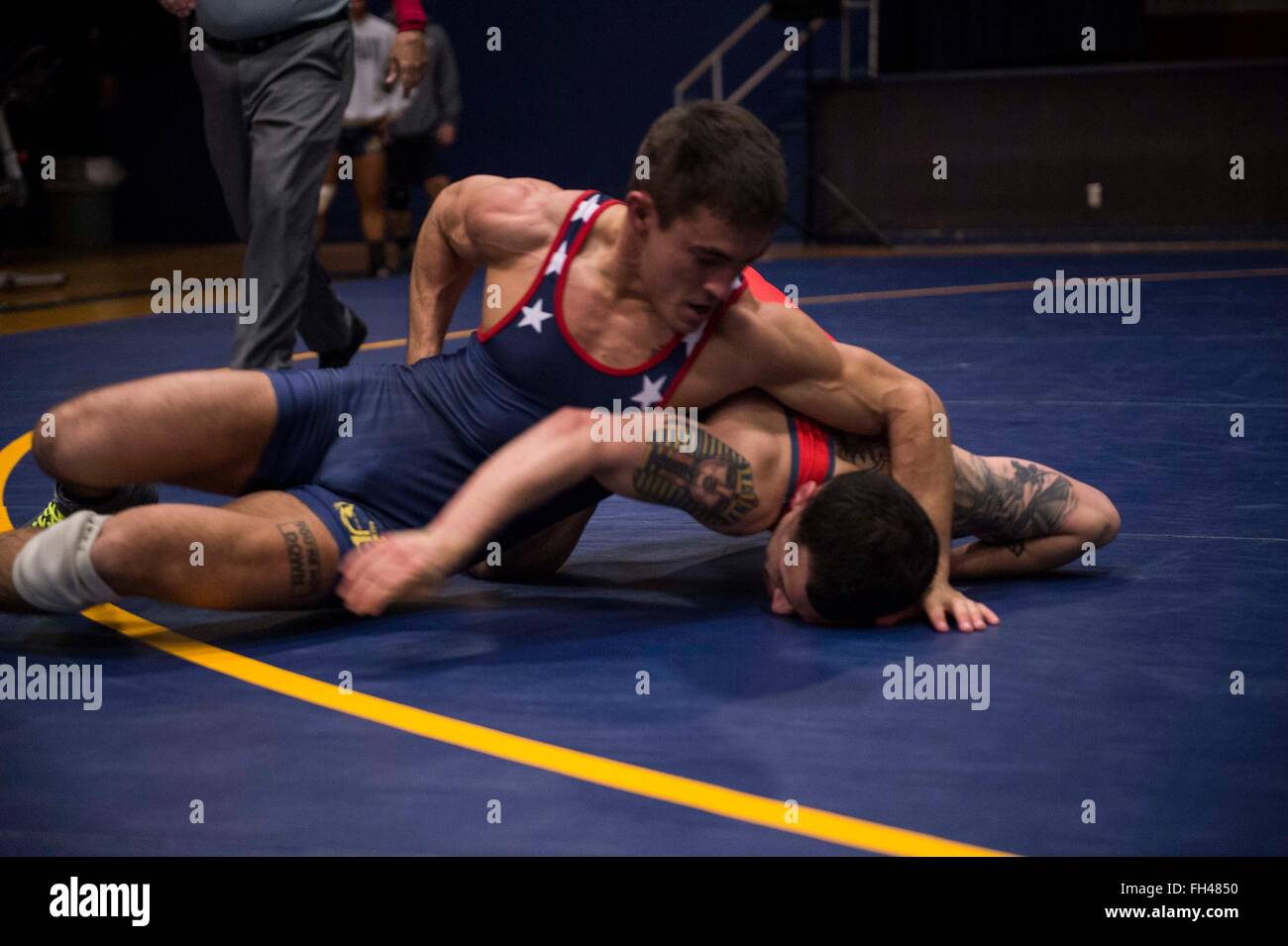 BREMERTON, Wash. (Feb 21, 2016) - Fireman Ryan Schmehr, a San Diego native stationed with USS Ronald Reagan (CVN 76), scrambles for position against Air Force Airman 1st Class Joey Garza in a 57kg Freestyle wrestling match during the 2016 Armed Forces Championship at Naval Base Kitsap-Bremerton. The tournament is held over two days, one for Greco-Roman style wrestling and the other Freestyle, between the Army, Navy, Marine Corps and Air Force. Stock Photo