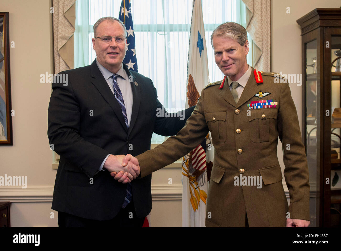 Deputy Secretary of Defense Bob Work greets Deputy Supreme Allied Commander Europe General Sir Adrian Bradshaw at the Pentagon, Feb. 22, 2016. The two leaders met to discuss matters of mutual importance. Stock Photo