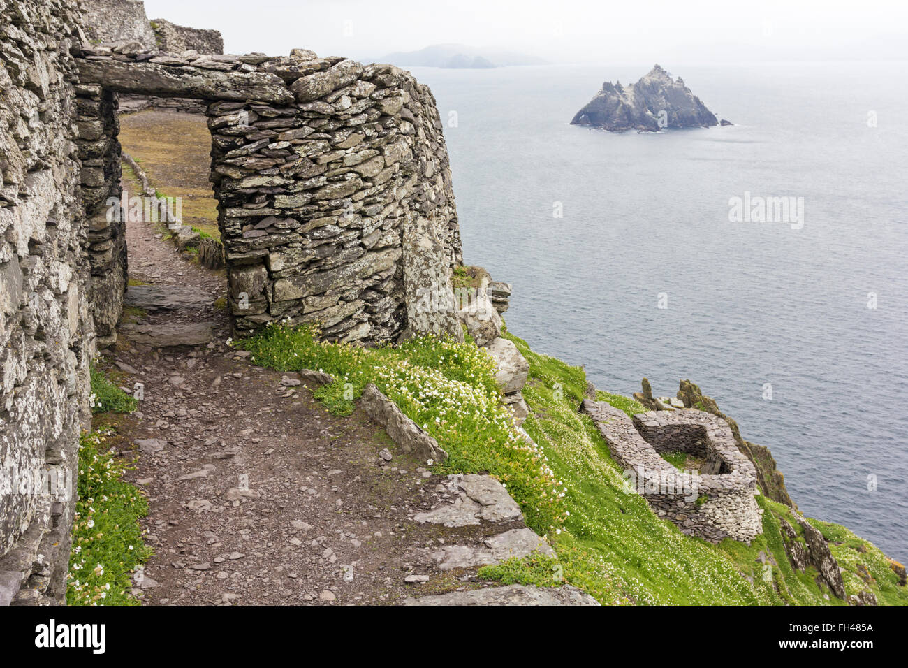 Entrance doorway to beehive huts, clochan, Skellig Michael,Kerry,Ireland, view over to Iveragh peninsula and Little Skellig Stock Photo