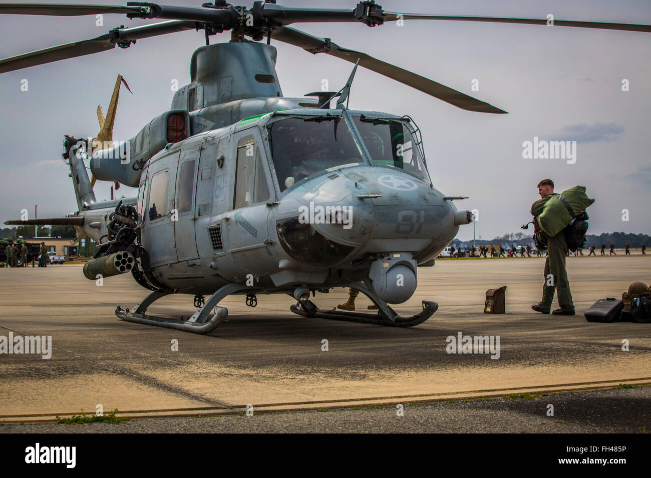 A Marine unloads flight gear from a UH-1Y Venom on the flight line aboard Marine Corps Air Station Beaufort, Feb. 22. Squadrons from MCAS Cherry Point will visit MCAS Beaufort to participate in Exercise Eager Response Feb. 24-28. Eager Response is a Battalion sized tactical insertion and combined arms exercise with units from 2nd Marine Aircraft Wing from MCAS Cherry Point, N.C. and 2nd Marine Division from Marine Corps Base Camp Lejeune, N.C. The exercise will be conducted at Fort Stewart, Georgia. F/A-18C Hornets from MCAS Beaufort will also participate in the exercise providing close air su Stock Photo