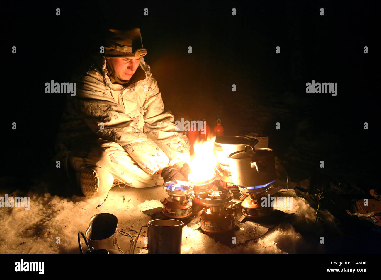 Corporal Charles Roy III, an optics technician assigned to The Combined Arms Company out of Bulgaria, uses small burners to melt snow into water as his unit sets up camp for the night. This unique company is comprised of multiple vehicles with multiple capabilities, including amphibious assault vehicles, M1A1 Abrams Main Battle Tanks and light armored vehicles. In the weeks leading up to exercise Cold Response 16, at the end of the month, the two nations have been conducting bilateral training to improve U.S. Marine Corps capability to operate in cold-weather environments. The exercise will fe Stock Photo