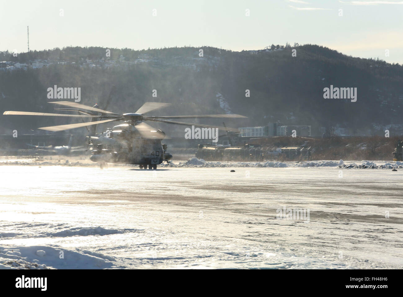 A CH-53E Super Stallion makes its way down the flight line at Vaernes, Norway, Feb. 22, 2016, as 2nd Marine Expeditionary Brigade prepares for Exercise Cold Response. All aircraft with Marine Heavy Helicopter Squadron (-) Reinforced, the Air Combat Element of 2d MEB, were dismantled at Marine Corps Air Station Cherry Point, N.C., and flown to Norway in U.S. Air Force C-5 Galaxies to provide air support during the exercise. Cold Response 16 is a combined, joint exercise comprised of 12 NATO allies and partnered nations and approximately 16,000 troops. Stock Photo