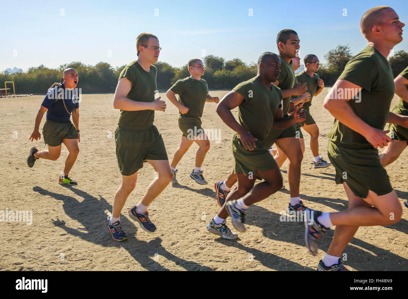 A drill instructor of Kilo Company, 3rd Recruit Training Battalion, instructs recruits to run faster during a physical training session at Marine Corps Recruit Depot San Diego, Feb. 22. If the recruits moved slowly, drill instructors motivated them to move faster and to get the most out of the session. Annually, more than 17,000 males recruited from the Western Recruiting Region are trained at MCRD San Diego. Kilo Company is scheduled to graduate May 6. Stock Photo