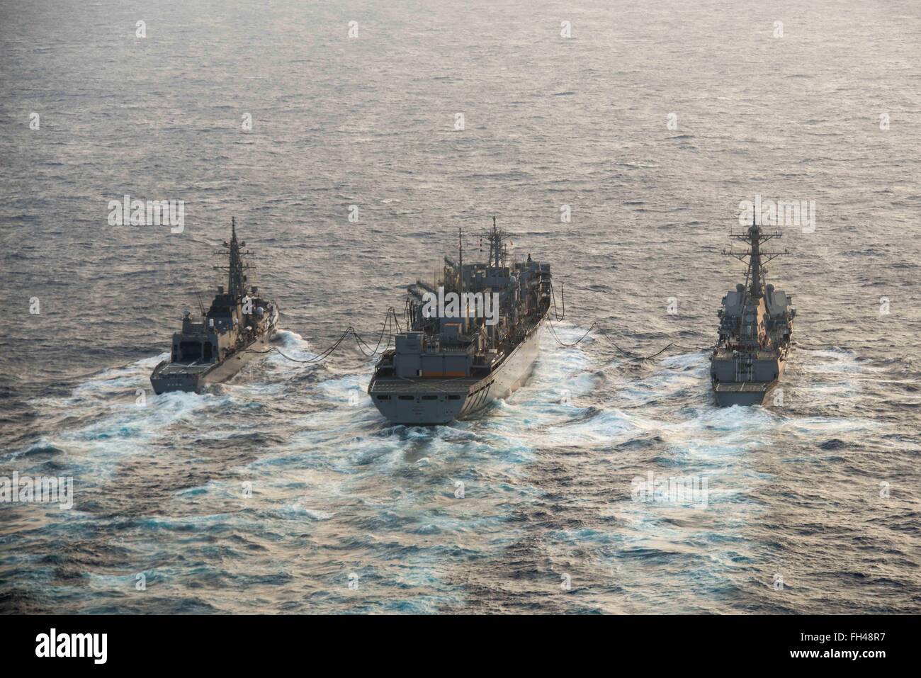 PHILIPPINE SEA (Feb. 22, 2016) - Japanese Maritime Self-Defense Force Murasame-class destroyer JDS Samidare (DD-106) and the guided-missile destroyer USS Stockdale (DDG 106) receive an advanced biofuel mixture from the fast combat support ship USNS Rainier (T-AOE 7) during a replenishment at sea. Providing a ready force supporting security and stability in the Indo-Asia-Pacific, the John C. Stennis Strike Group is operating as part of the Great Green Fleet on a regularly scheduled 7th Fleet deployment. Stock Photo