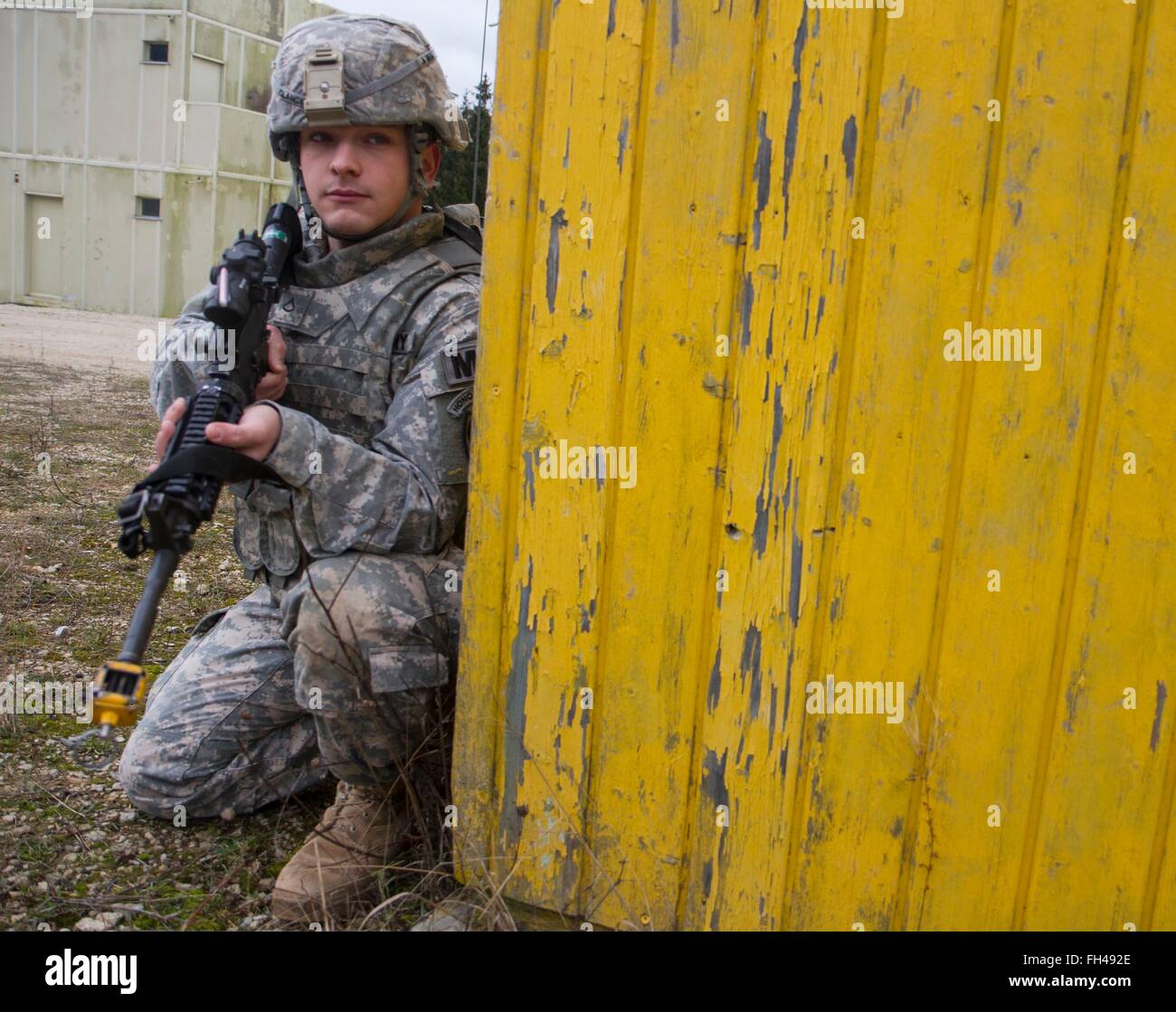 U.S. Army Pfc. Colin Clancy, a military policeman assigned to the 527th Military Police Company, 18th MP Brigade, pulls security while his team responds to an active-shooter scenario during a mission training exercise at the Joint Multinational Readiness Center in Hohenfels, Germany, Feb. 22. Clancy, a Syracuse, N.Y., native, is training at JMRC in preparation for peace support operations in Kosovo. Stock Photo