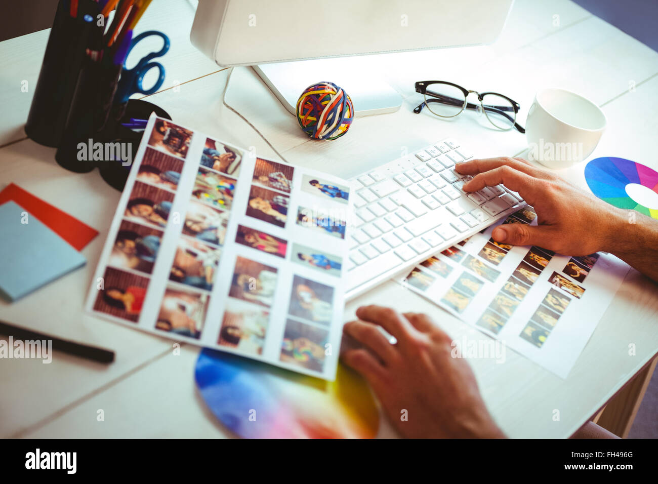 Man using his computer at his desk Stock Photo - Alamy
