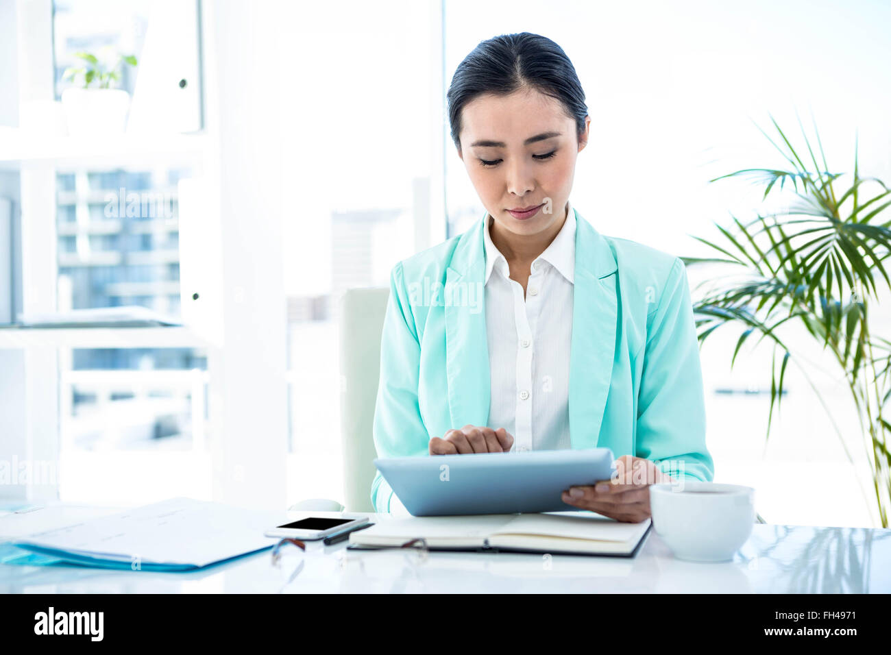 Businesswoman using her tablet pc Stock Photo