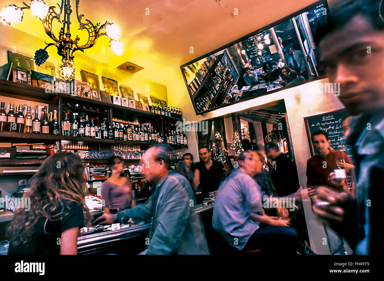 PARIS, France  - Adults Sharing Drinks inside French Wine Bar, in the Marais Area, 'Hortense' Night Stock Photo