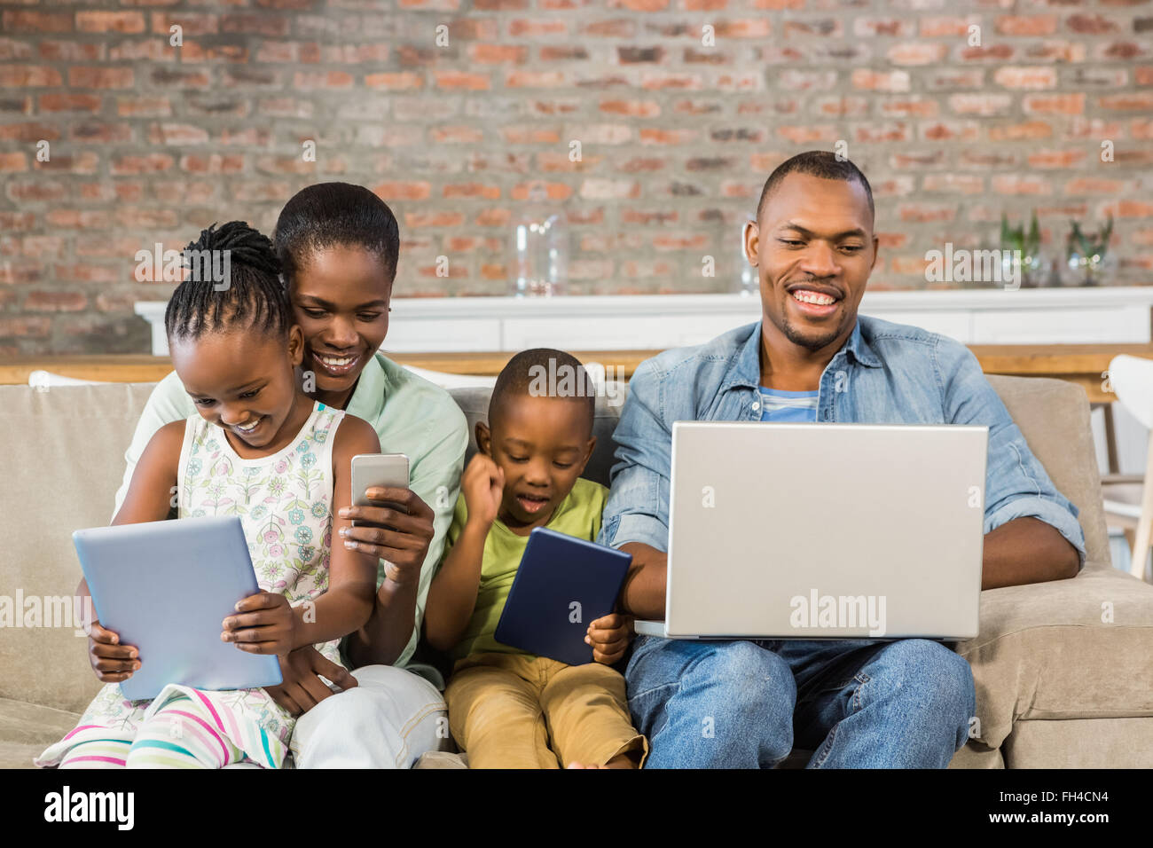 Happy family using technology together Stock Photo - Alamy